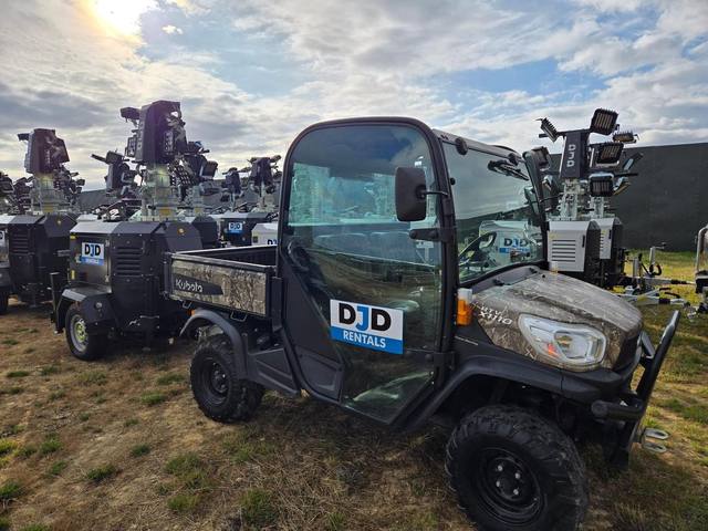 Site utility vehicle and tower lights at an event compound