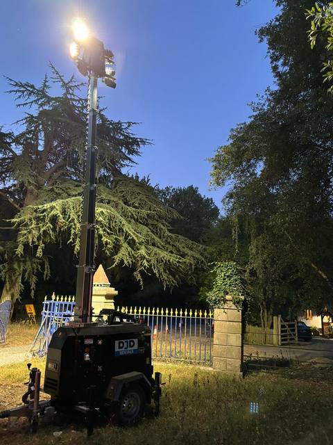 Tower light lighting an event entrance and gates at night