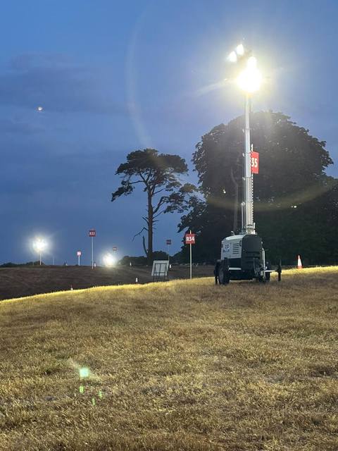 Tower light on a festival walkway after dark