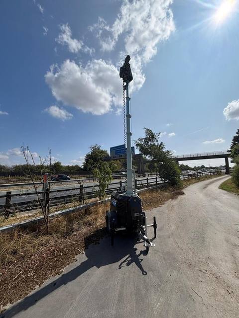 Tower light positioned on a site access road